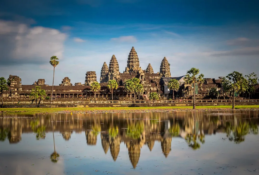 Sunrise reflection of Angkor Wat temple complex in calm water, Siem Reap, Cambodia